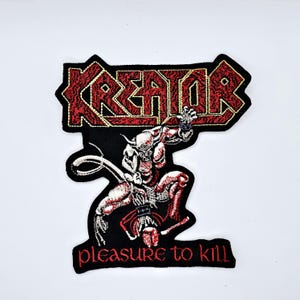 May include: Embroidered patch featuring the word "KREATOR" in red, stylized lettering with a black border. Below the word is a detailed illustration of a demonic figure in red and white, with the text "pleasure to kill" below.