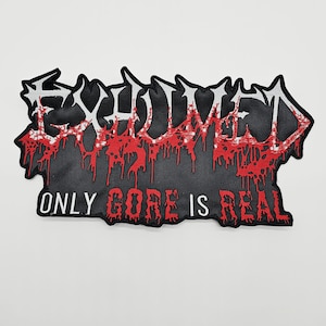May include: A black embroidered patch featuring the word EXHUMED in a stylised, jagged white font with red dripping accents. Below the main text, the phrase ONLY GORE IS REAL is embroidered in a bold, red, dripping-style font on a black background.