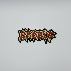 May include: Embroidered patch featuring the word "EXODUS" in a stylized, jagged font. The text is red with a yellow outline, set against a black background. The patch is likely for clothing or accessories.
