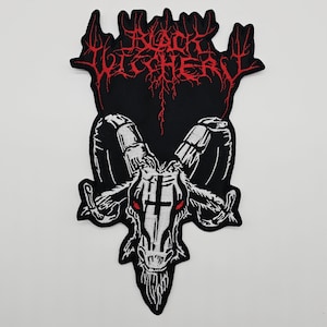 May include: Black embroidered patch featuring a white goat skull with red eyes and a cross on its forehead. The patch has the words "Black Witchery" in red, stylized lettering above the skull. The patch is on a black background.