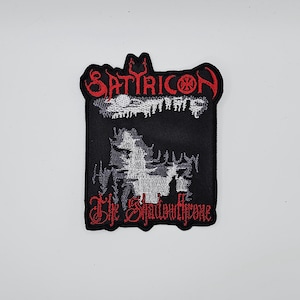 May include: Black embroidered patch with the band name "SATYRICON" in red, above a white and grey graphic. The text "The Shadowthrone" is in red script below the graphic. The patch has a black border.