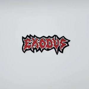 May include: Embroidered patch with the word "EXODUS" in red, stylized lettering and a jagged black border. The patch is designed for application on clothing or accessories.