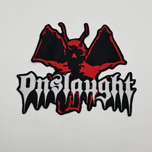 May include: Embroidered patch featuring a red and black demon-like figure with spread wings. The word "Onslaught" is written in white, gothic-style lettering below the figure. The patch has a black border and is likely for clothing or accessories.