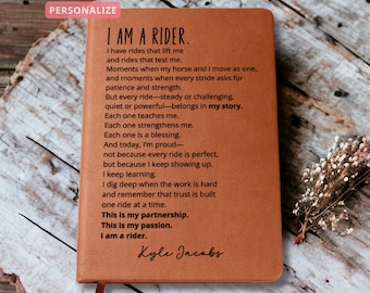 May include: A brown leather journal with the text "I AM A RIDER" and a poem about riding. The journal is personalized with the name "Kyle Jacobs". The word "PERSONALIZE" is in the top left corner.