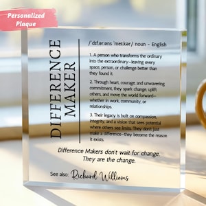 May include: A clear, rectangular plaque with the words "DIFFERENCE MAKER" in black. The plaque includes a definition and inspirational text. A pink banner at the top reads "Personalized Plaque".