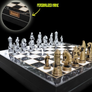 May include: A black and white marble chessboard with silver and gold chess pieces. The board has a personalised nameplate that says "Daniel".
