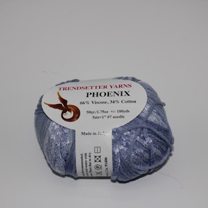 May include: A skein of blue yarn labeled "Trendsetter Yarns Phoenix 66% Viscose, 34% Cotton 50gr/1.75oz +/- 100yds 5sts-1" #7 needle Made in Italy"