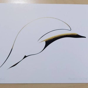 May include: Abstract art print featuring a stylized bird in flight. The artwork uses flowing lines in black, gold, and tan against a white background. The print is signed and dated. The overall design is minimalist and elegant.