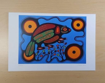 May include: A colorful, stylized illustration of a beaver on a blue background. The beaver is depicted in red, green, black, and orange. The background features three orange circles with black centers.