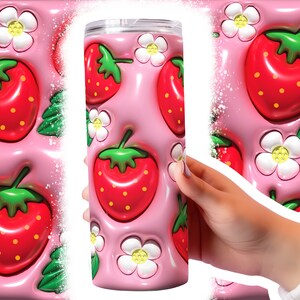 May include: A pink stainless steel tumbler with a 3D design of strawberries and white flowers. The tumbler is made to look like the strawberries and flowers are popping out of the surface.