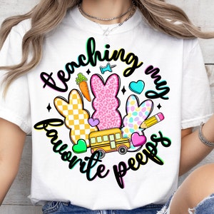 May include: White t-shirt with a colorful graphic design that says "Teaching my favorite peeps". The graphic includes a school bus, carrots, and colorful Easter Peeps.