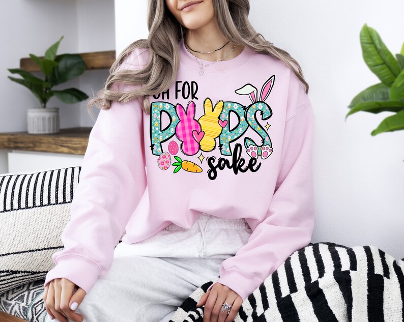May include: Pink sweatshirt with a graphic of Easter bunnies and the text "Oh for pups sake".