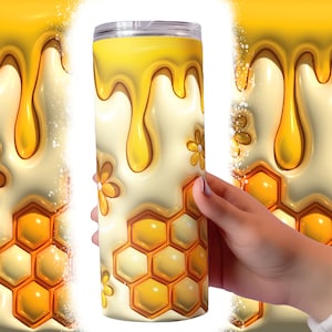 May include: A stainless steel tumbler with a white and yellow design. The design features a honeycomb pattern, dripping honey, and yellow flowers.