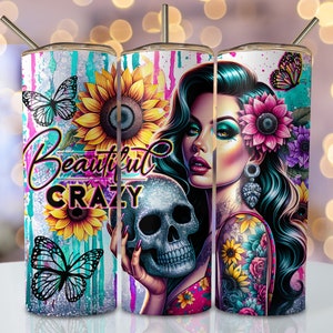 May include: A set of three stainless steel tumblers with colorful designs. The tumblers feature a woman with a skull, butterflies, sunflowers, and the text "Beautiful Crazy".