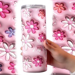 May include: A pink stainless steel tumbler with a 3D daisy pattern. The daisies are white, pink, and purple.