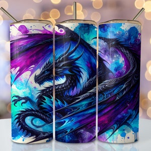 May include: Three stainless steel tumblers with a watercolor design of a blue dragon with purple and blue wings. The dragon is set against a white background with blue and purple watercolor splatters.