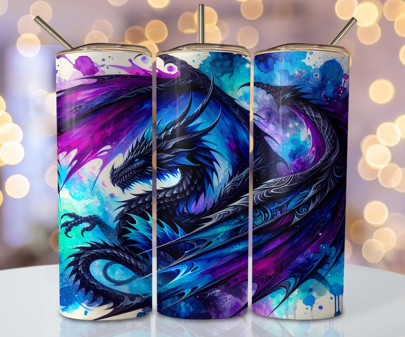 May include: Three stainless steel tumblers with a watercolor design of a blue dragon with purple and blue wings. The dragon is set against a white background with blue and purple watercolor splatters.
