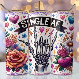 May include: Three white stainless steel tumblers with a colorful design featuring a skeleton hand giving the 'rock on' sign, hearts, flowers, and the text 'Single AF'.
