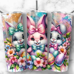 May include: Three stainless steel tumblers with a spring-themed design. Each tumbler features a different pastel-colored bunny with a bow and surrounded by colorful flowers. The tumblers are perfect for spring celebrations.