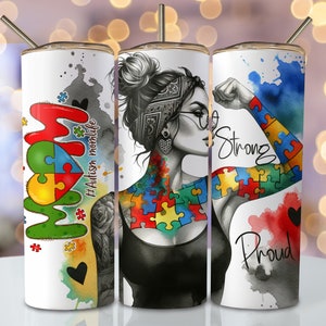May include: Three stainless steel tumblers with a white background and colorful designs. The first tumbler features the word "MOM" with a puzzle piece heart and the text "#Autism momlife". The second tumbler features a woman with a puzzle piece tattoo and glasses. The third tumbler features a woman's arm with a puzzle piece tattoo and the text "So Strong" and "Proud".