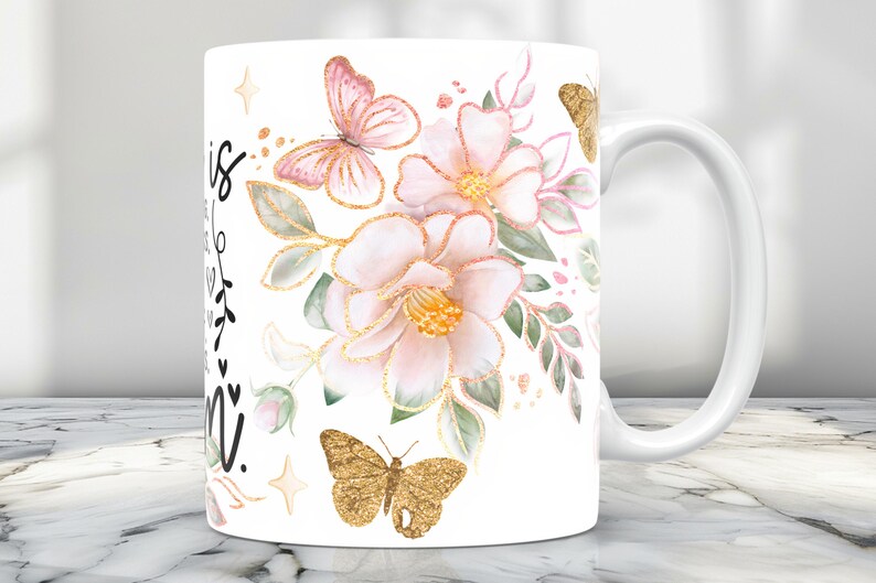 May include: White ceramic mug with a floral design featuring pink and gold butterflies. The mug has a black inscription that reads "This is my happy place".