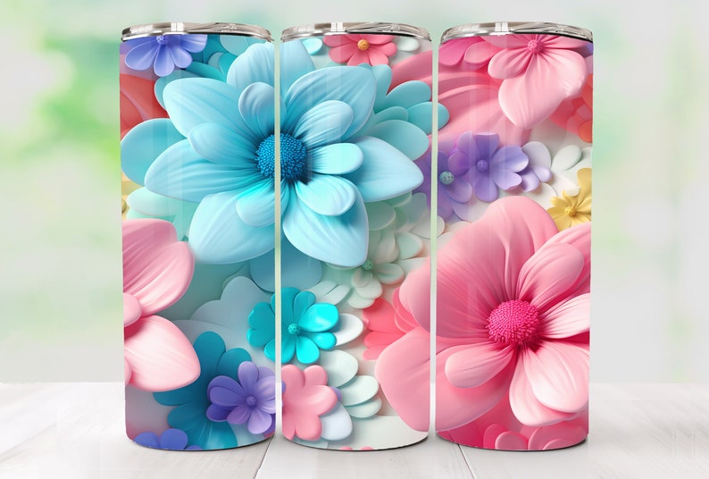 May include: Three stainless steel tumblers with a floral design. The tumblers feature a variety of pink, blue, and purple flowers.