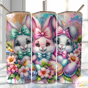 May include: Three sublimation tumblers with a design of three cartoon bunnies wearing bows and holding Easter eggs. The bunnies are surrounded by pink, white, and green flowers. The background is a glittery, pastel design.