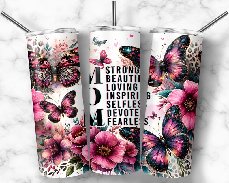 May include: Three stainless steel tumblers with a white background and a floral design. The tumblers feature a pink and purple butterfly with glitter accents. The middle tumbler has the word "MOM" in large black letters and the words "Strong, Beautiful, Loving, Inspiring, Selfless, Devote, Fearless" in smaller black letters.