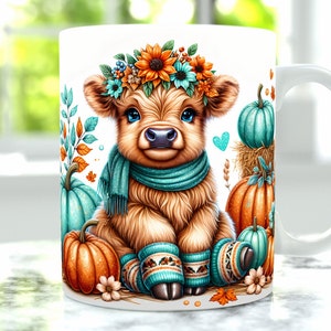 May include: A white ceramic mug with a brown and white Highland cow wearing a teal scarf and leg warmers. The cow is surrounded by fall-colored pumpkins and leaves.