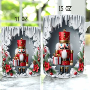 May include: Two white ceramic mugs featuring a Christmas nutcracker design. The mugs are 11 oz and 15 oz. The nutcracker is holding a gift and is surrounded by holly and snowflakes.