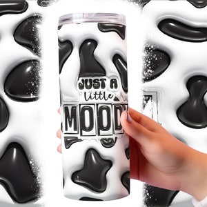 May include: A white and black cow print tumbler with the text "Just a little moody" in black letters.