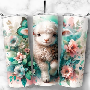 May include: A white stainless steel tumbler with a watercolor design of a cute lamb with curly fur, surrounded by pink and blue flowers and butterflies. The background is a light blue watercolor wash.