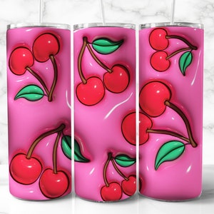 May include: A set of three pink tumblers with a repeating pattern of red cherries and green leaves. The cherries have a glossy, 3D effect, and the background is a smooth, glossy pink. Each tumbler has a straw.