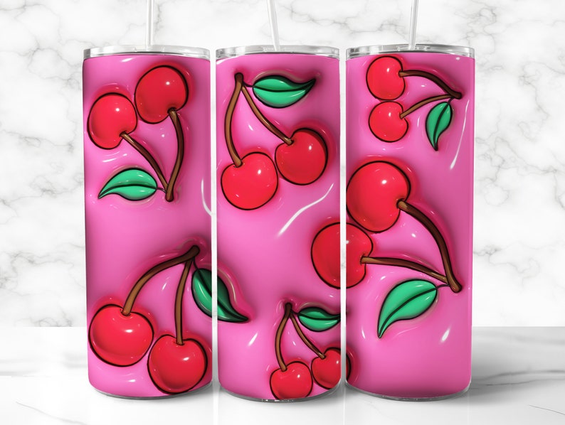 May include: A set of three pink tumblers with a repeating pattern of red cherries and green leaves. The cherries have a glossy, 3D effect, and the background is a smooth, glossy pink. Each tumbler has a straw.