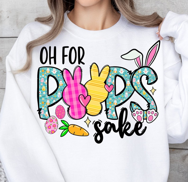 May include: White sweatshirt with a graphic design of pastel colored Easter eggs, bunnies, and the text "Oh for Pups sake".