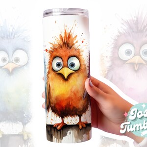 May include: A stainless steel tumbler with a watercolor design of a cartoon bird with a surprised expression. The bird is orange, yellow, and brown with blue eyes. The background is white with splatters of paint.