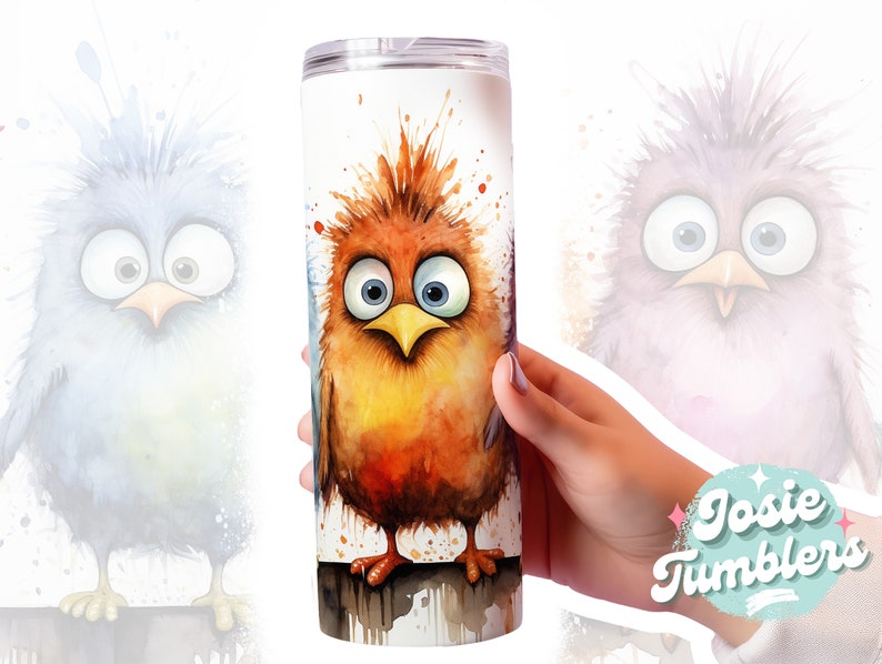 May include: A stainless steel tumbler with a watercolor design of a cartoon bird with a surprised expression. The bird is orange, yellow, and brown with blue eyes. The background is white with splatters of paint.