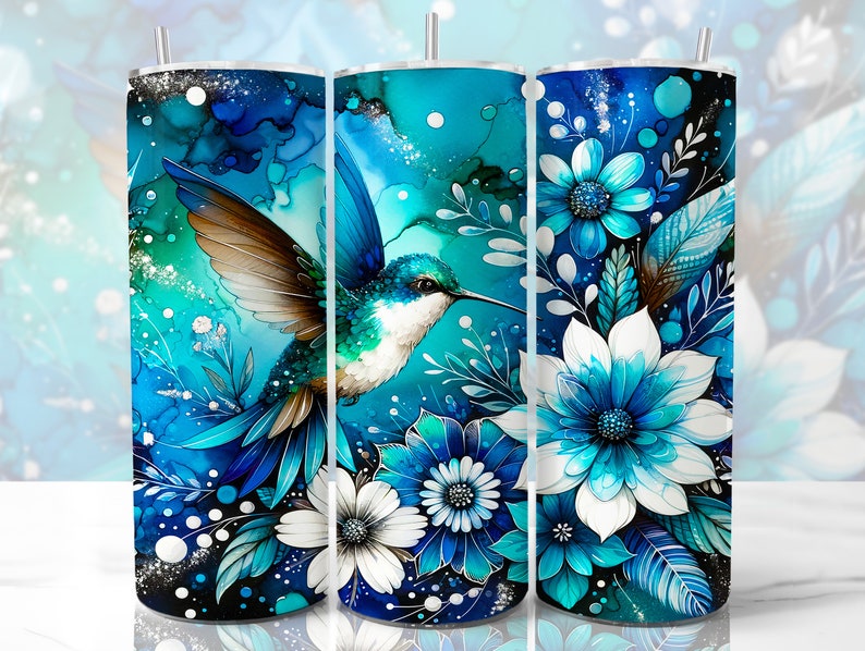 May include: A blue and white tumbler with a hummingbird and floral design. The hummingbird is flying with its wings spread. The flowers are in shades of blue and white.