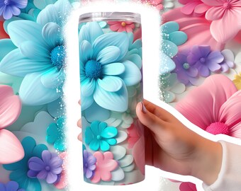 May include: A stainless steel tumbler with a colorful floral design. The tumbler features a variety of flowers in shades of blue, pink, and purple.
