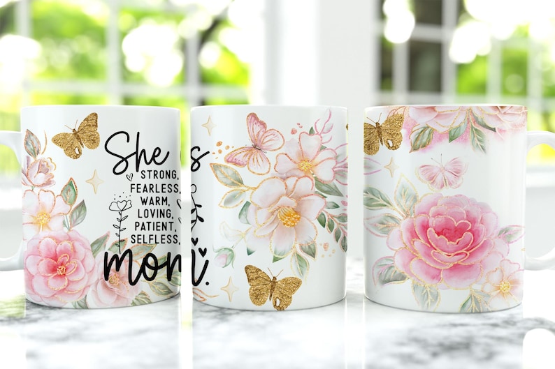 May include: White ceramic mug with a floral design featuring pink and gold butterflies. The mug has a black text that reads "She's strong, fearless, warm, loving, patient, selfless, mom."