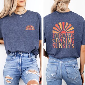 a woman wearing a blue shirt that says forever chasing sunsets