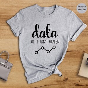 May include: Gray t-shirt with the text "data or it didn't happen" and a line graph graphic.