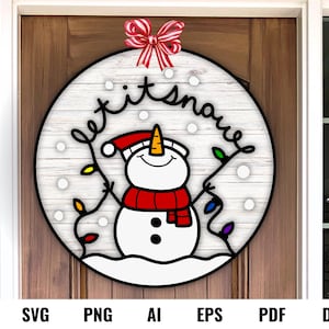 May include: A white wooden round sign with the text "Let it snow" in black script. A snowman with a red scarf and a carrot nose is in the center of the sign. The sign is decorated with red and white bow and colorful lights.
