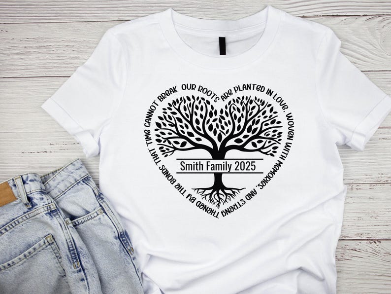 May include: White t-shirt with a black tree design and the text "TIME CANNOT BREAK OUR ROOTS ARE PLANTED IN LOVE, WOVEN WITH MEMORIES, AND STRENGTHENED BY THE BONDS THAT TIME CANNOT BREAK" around the tree. The tree has a banner that says "Smith Family 2025".