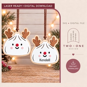 May include: Two wooden dumpling ornaments with brown reindeer antlers, red noses, and pink cheeks hanging from brown cords. One ornament features the name Kendall in black text. The design includes text reading LASER READY DIGITAL DOWNLOAD.