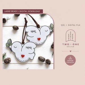 May include: Two white bird-shaped ornaments with brown leather hanging cords. Each bird features a small red heart, a green leaf sprig, and black text reading "FRIENDS" or "FOREVER" with "I have one, you have one" printed along the bottom edge.