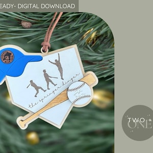 May include: A baseball-themed ornament featuring a blue baseball cap, a baseball bat, and a baseball. The ornament has the text "the springer dinger" and silhouettes of baseball players. The ornament is a digital download.