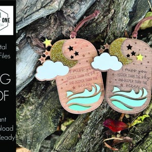 May include: Two wooden ornaments with a blue and green wave design and the text "I miss you higher than the sky and deeper than the ocean".