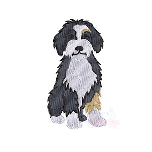 May include: An embroidered design of a seated dog with black, white, and tan fur. The dog has a fluffy appearance with detailed stitching, showcasing its fur texture. The design is on a white background, highlighting the dog's features.