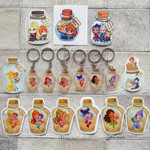 May include: A selection of stickers and keyrings depicting cartoon characters within glass potion bottles. The bottles have cork stoppers and tags that read "Happiness Potion". The characters are in various poses and colours.